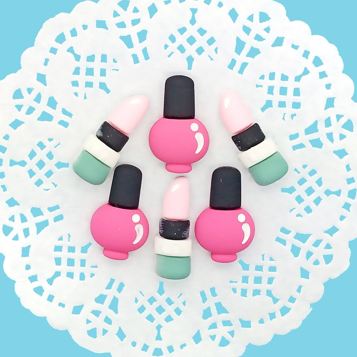 Nail polish and lipstick makeup resin flatback cabochons in pink blue and black.