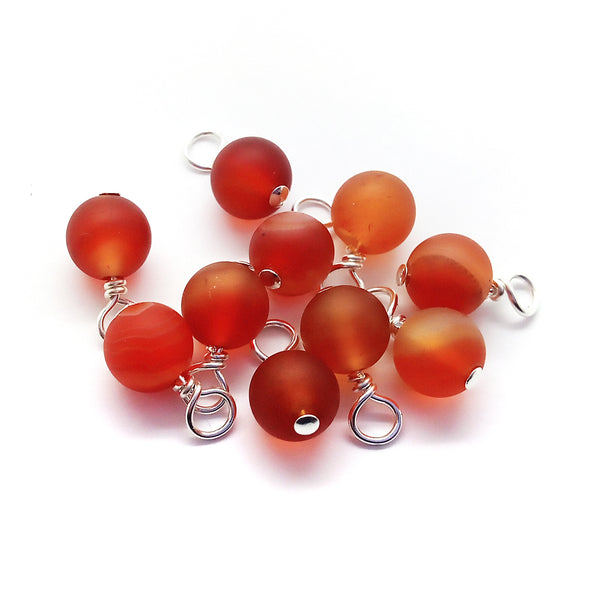Red and orange natural bead charm dangles made from 6mm matte red and orange beads.