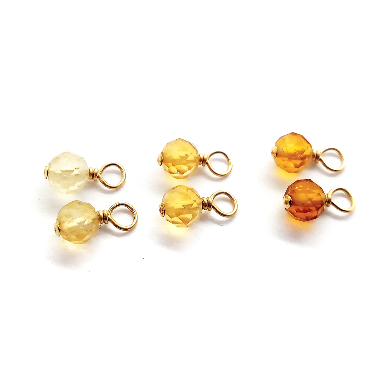 Citrine gemstone bead charms are tiny 4mm dangles for June birthstone jewelry, in shades of light yellow to orange.