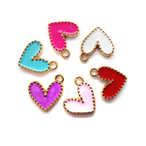 Metal heart charms with bright enamel in blue, pink, red, purple, blue and white on a gold tone base.