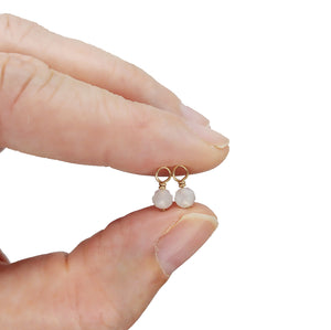 Tiny moonstone bead dangles are used for dainty June birthstone jewelry.