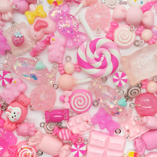 Cute pink candy charms in a variety of styles (chocolate, lollipops, hard candy). Grab bag mix of 25 pieces. Made of resin cabochons, metal charms, and acrylic charms and beads.