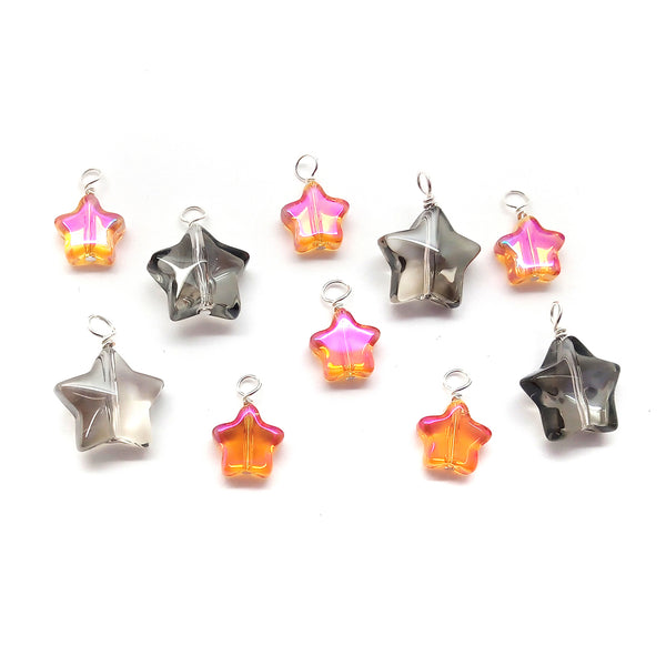 Glass bead star dangle charms in transparent gray/black and orange/red/pink.