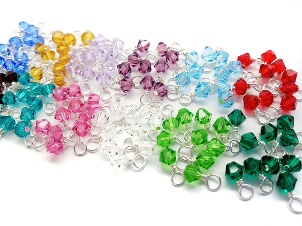 Beautiful layout of colorful 4mm crystal bicone bead charms in birthstone colors.